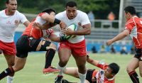 Tonga&#039;s Taione Vea is tackled on test debut against Japan in 2013. Photo: AFP