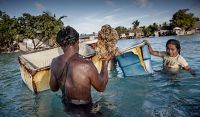 Villagers in Kiribati, which the World Bank says should be allowed to work and permanently settle in Australia and New Zealand