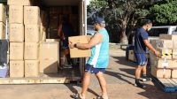 Moana Pasifika players Isi Tu&#039;ungafasi and Don Lolo Penitau Finau loading up the containers of supplies for Tonga Photo: Moana Pasifika