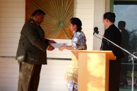 Miss Anna Jane Vea receiving her certificate from Brigadier Fielakepa and New Zealand High Commissioner Her Excellency Sarah Walsh