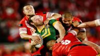 Boyd Cordner of Australia is tackled by Tuimoala Lolohea and Sika Manu of Tonga during the Test between Tonga and Australia in October last year 