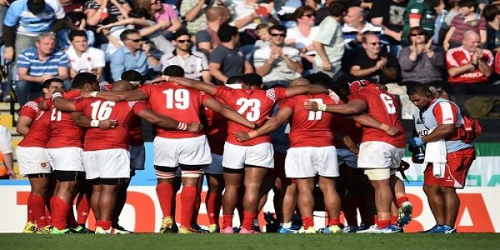 The Tongan team huddle together following their Rugby World Cup defeat to Argentina. Photo: AFP