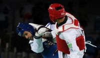 Pita Taufatofua jnr (Blue) of Tonga (TGA) against Sajjad Mardani (Red) of Iran (IRI) during first bout of Men’s +80kg Division at the Rio 2016 Games.